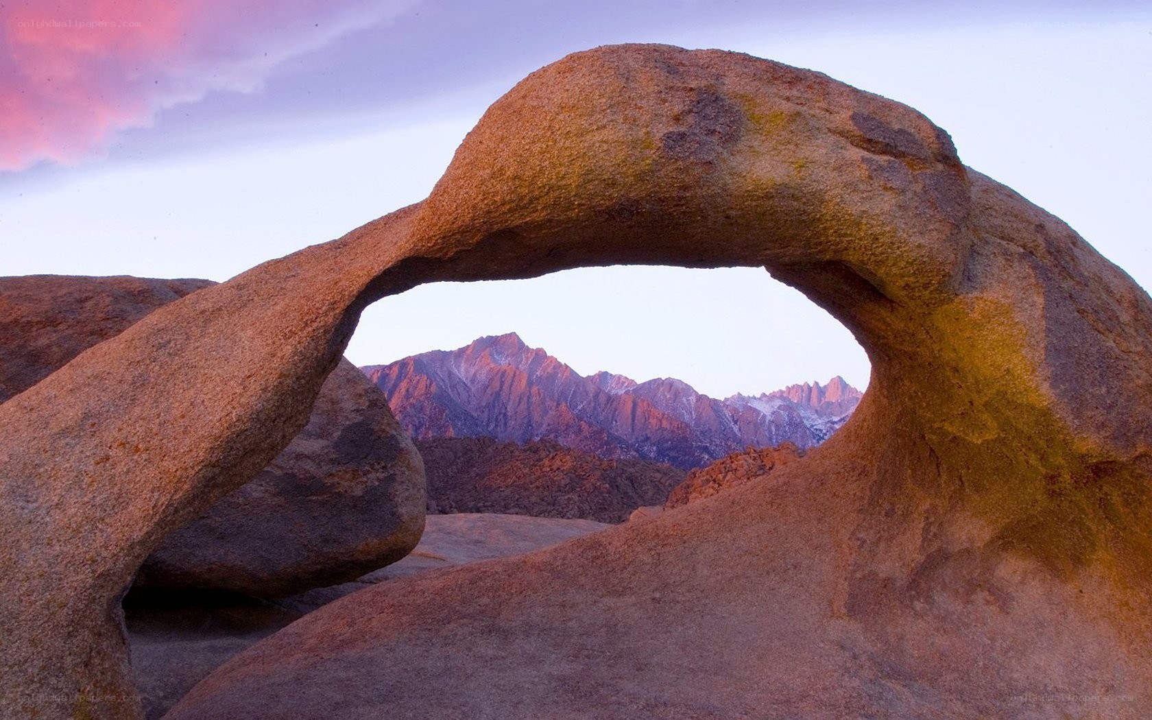 Natural rock arch with mountain view