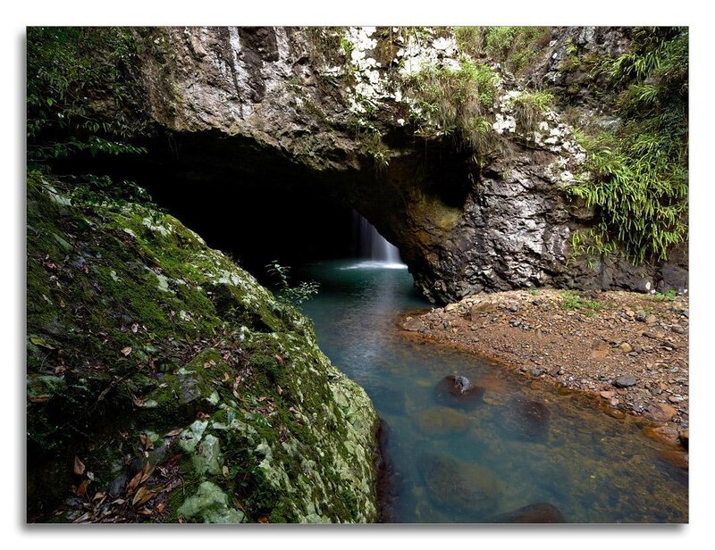 Natural rock arch with waterfall