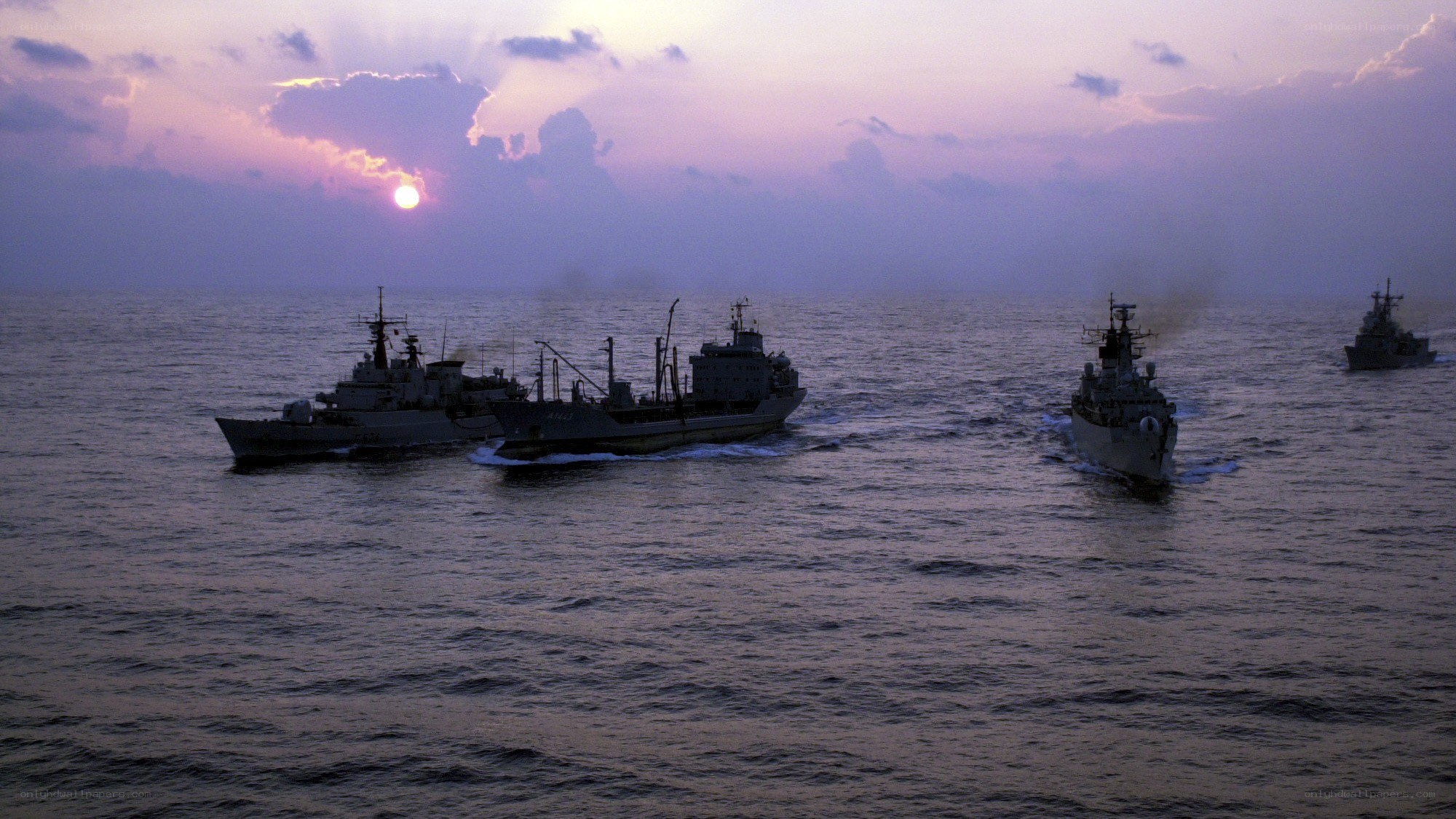 Naval fleet at sunset