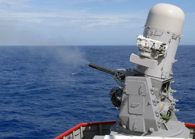 Naval gun firing at sea