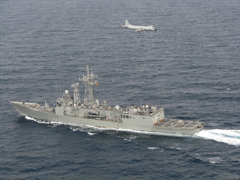 Naval ship and aircraft at sea