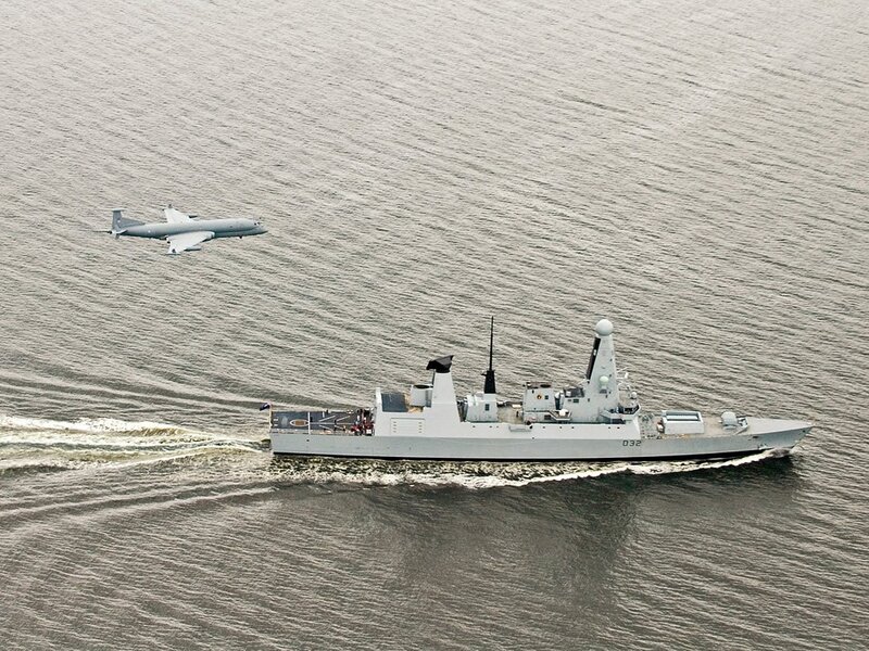 Naval ship and aircraft in flight