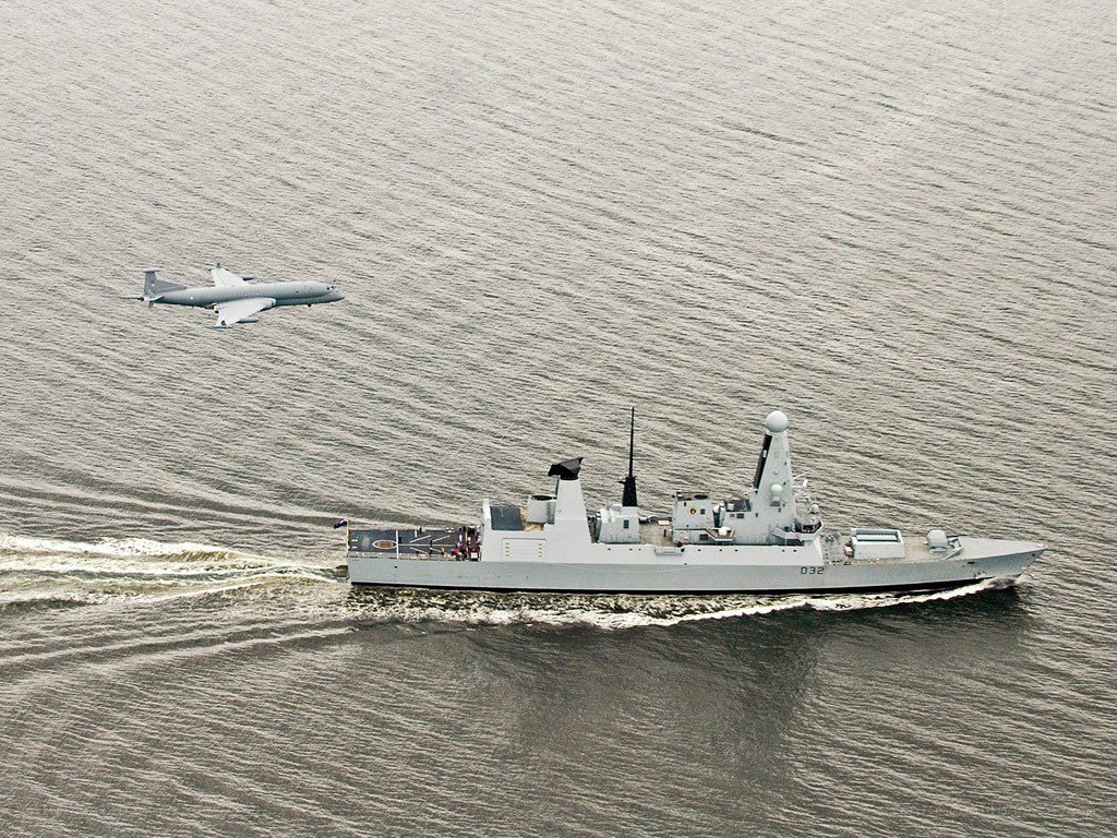 Naval ship and aircraft in flight