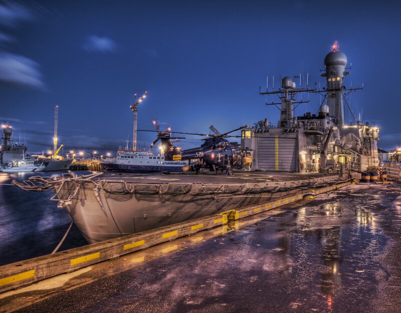 Naval ship at dock at night