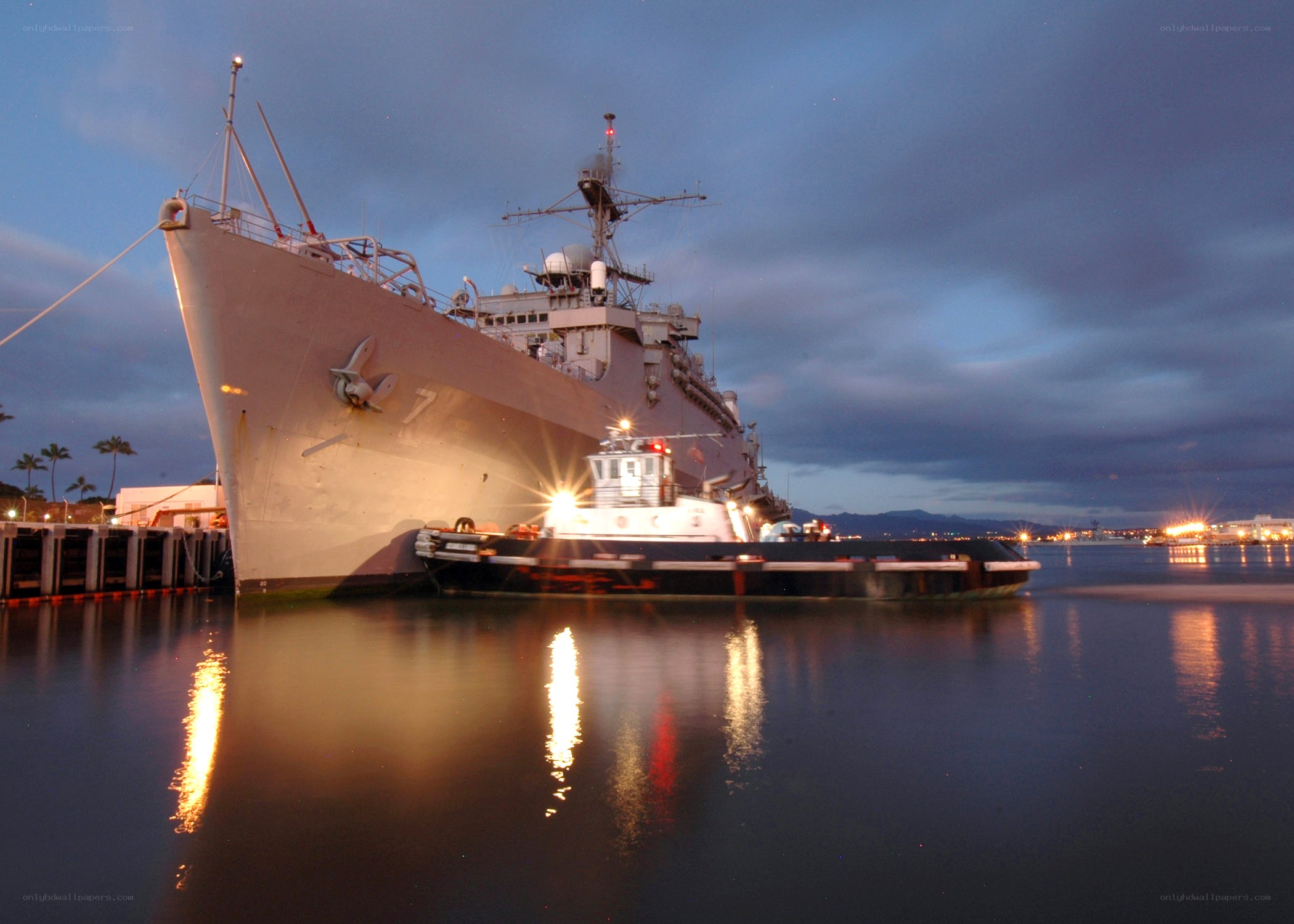 Naval ship at dock in evening