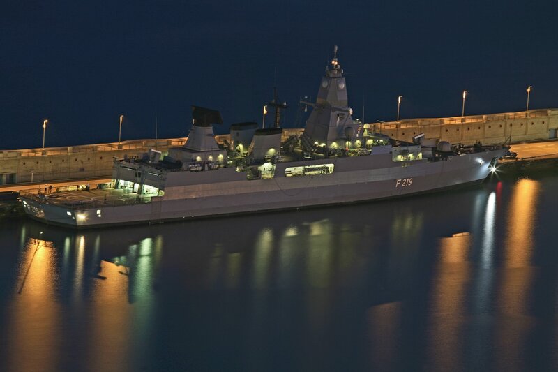 Naval ship at night in port