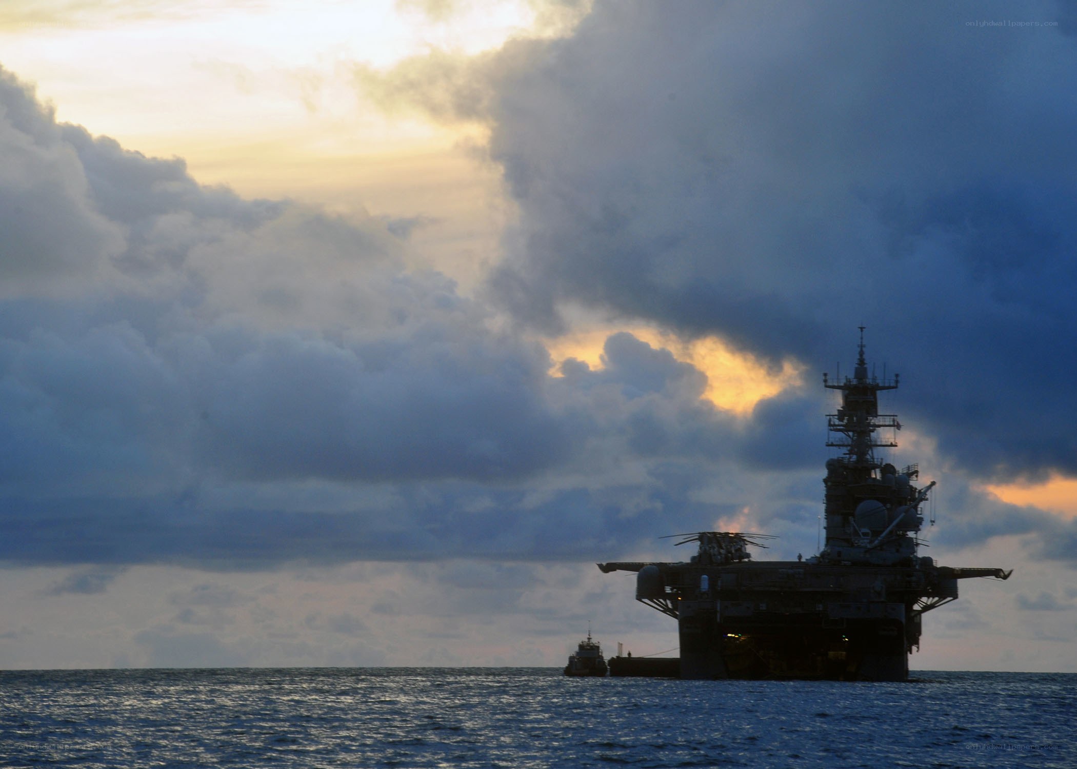 Naval ship at sea during sunset
