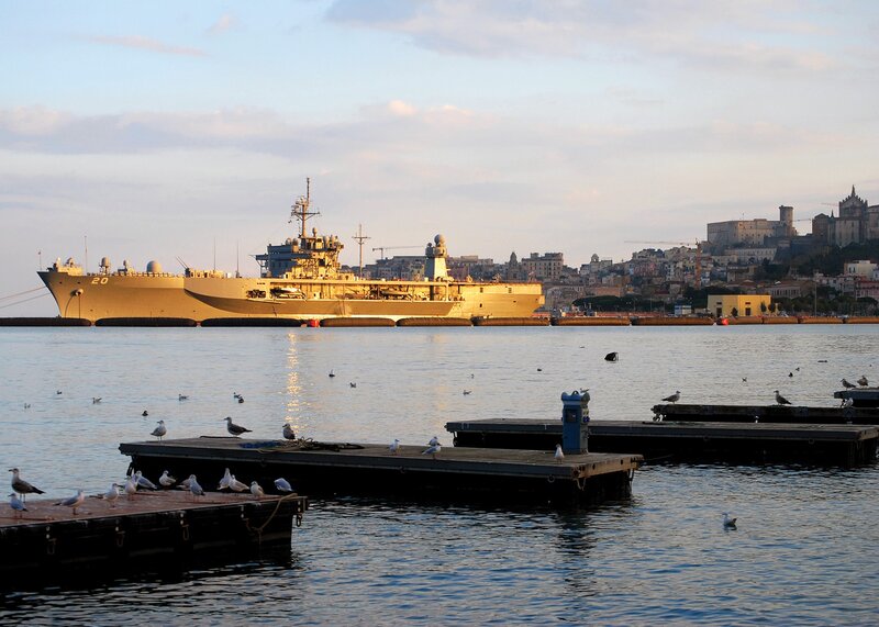 Naval ship in harbor at dusk