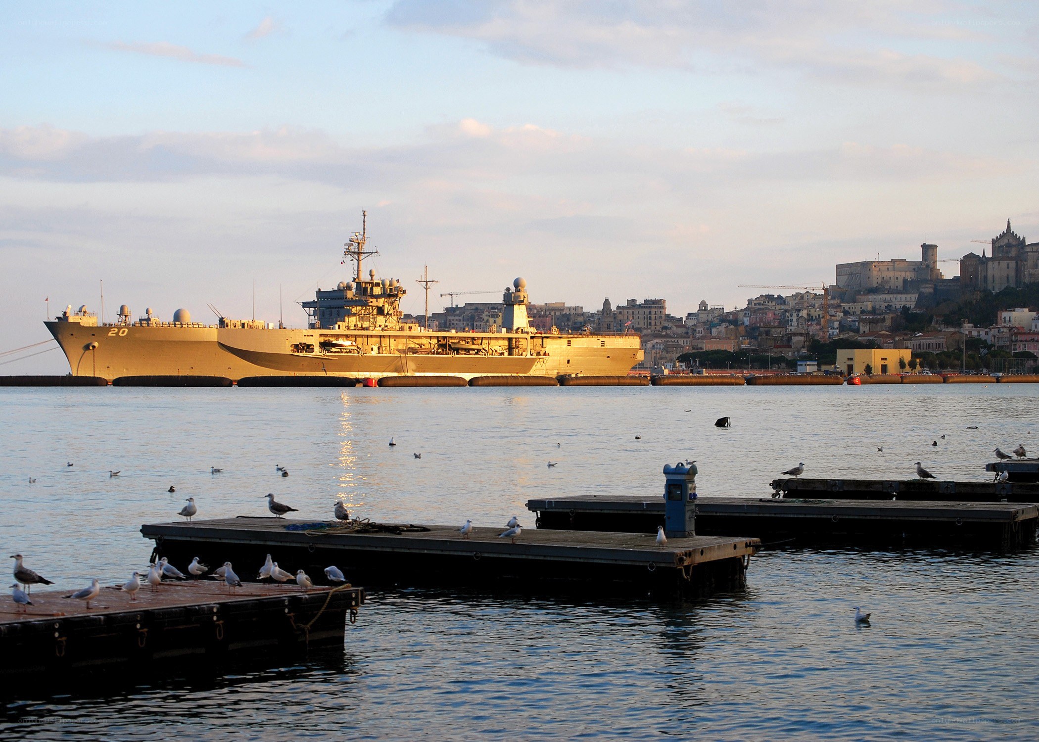 Naval ship in harbor at dusk