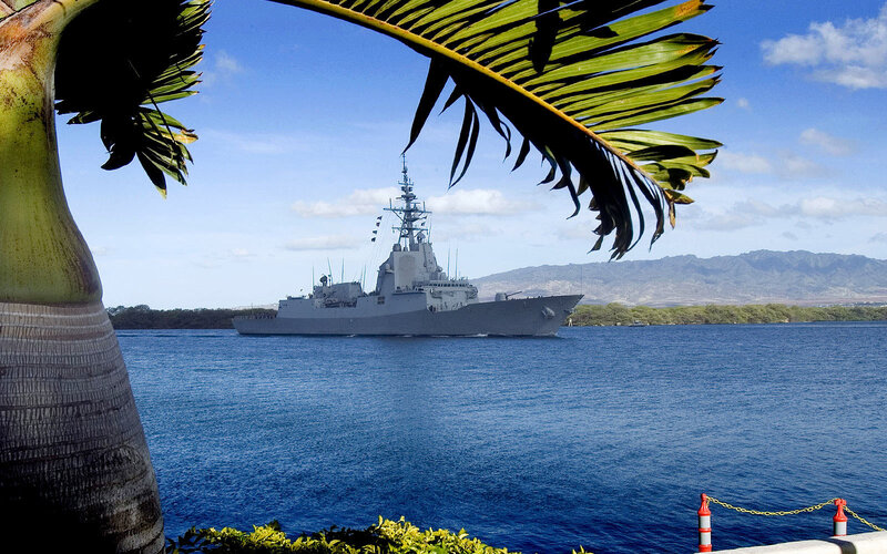 Naval ship in tropical harbor