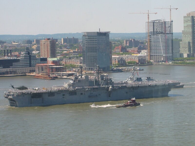 Naval ship in urban harbor