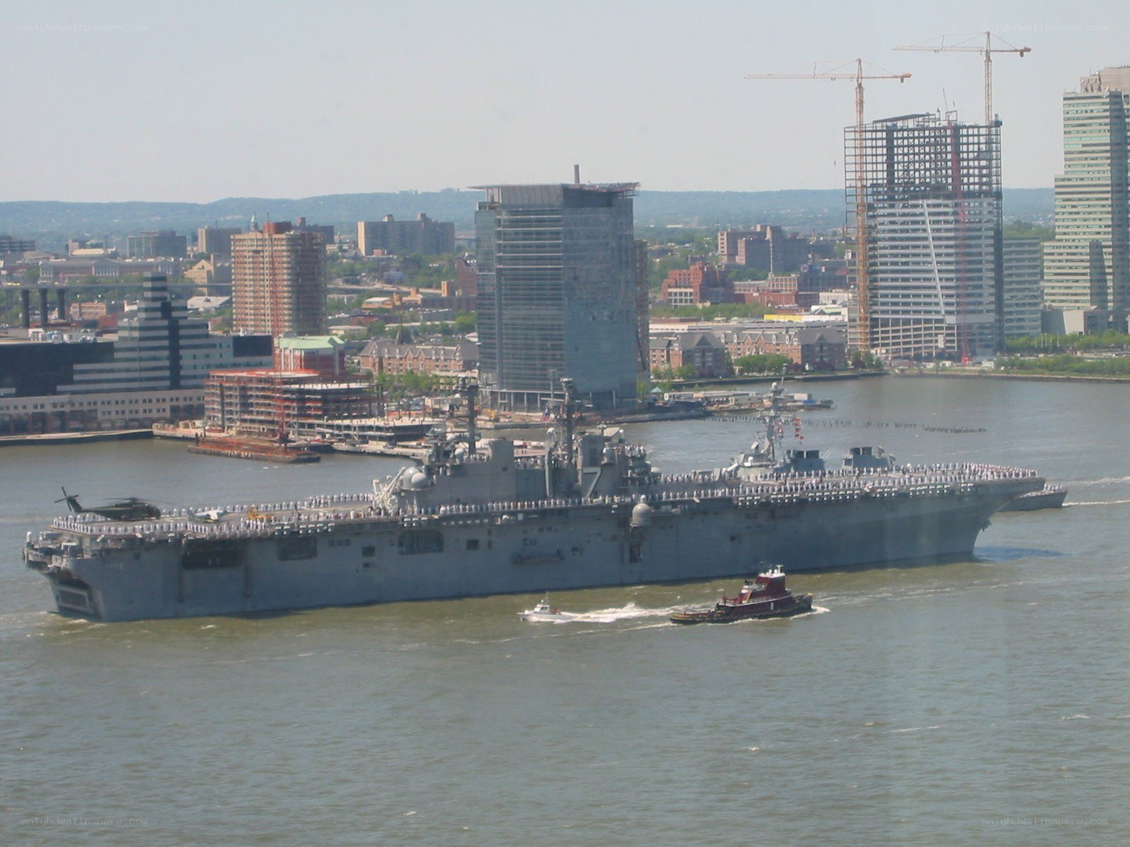 Naval ship in urban harbor
