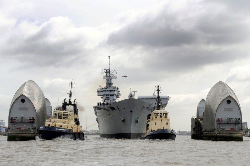 Naval ship passing through bridge