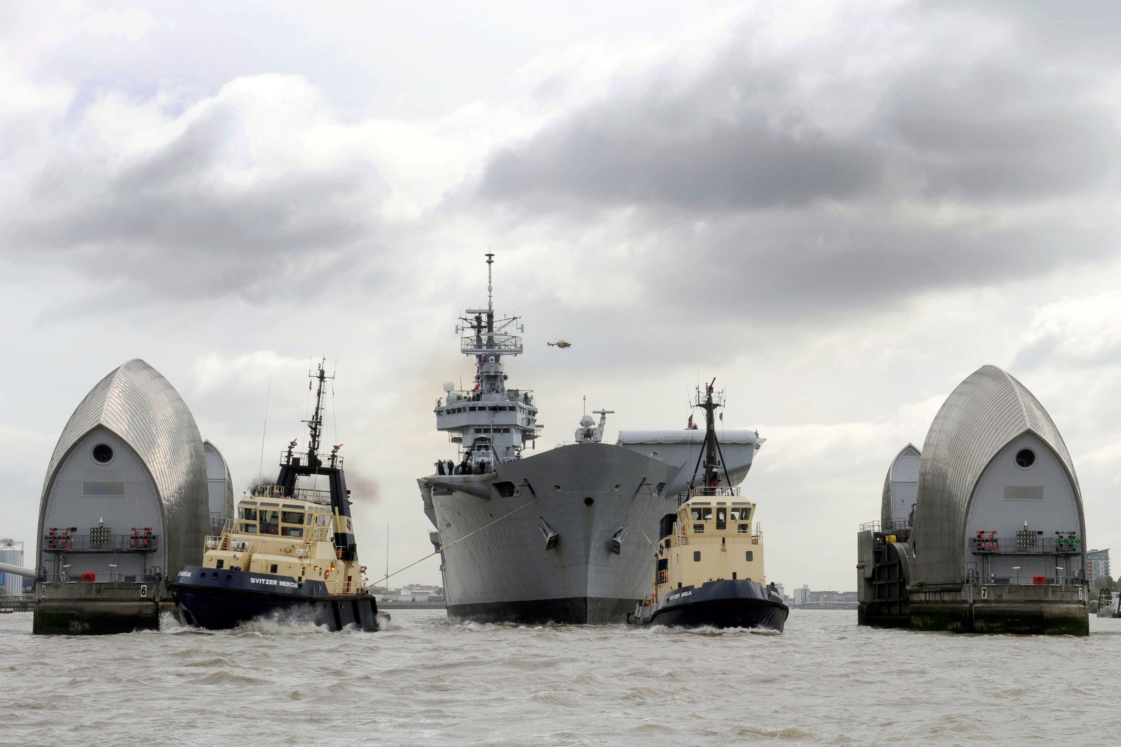 Naval ship passing through bridge
