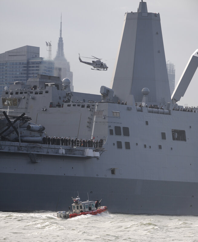 Naval ship with helicopter and coast guard boat