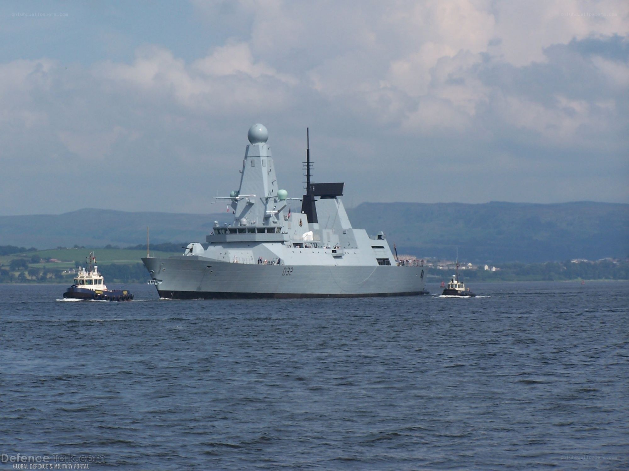 naval ship with tugboats