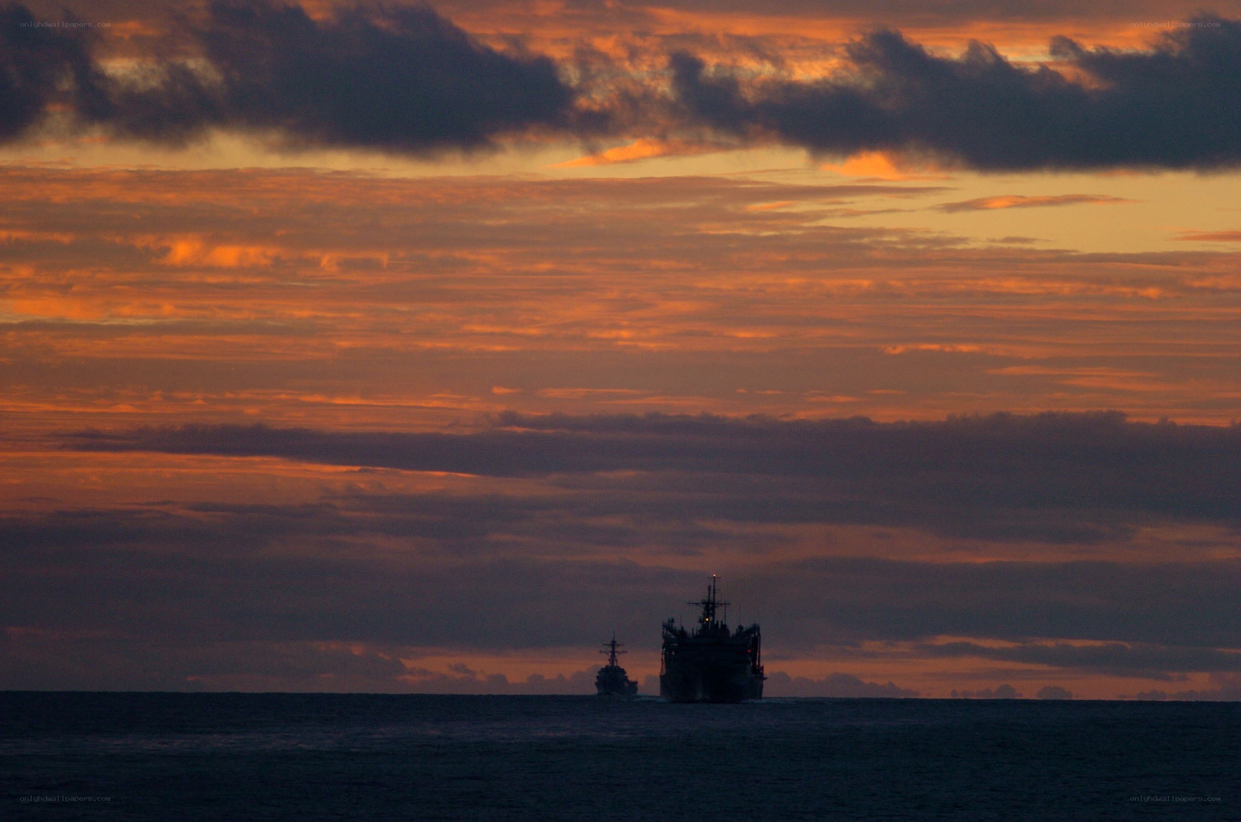 Naval ships at sunset