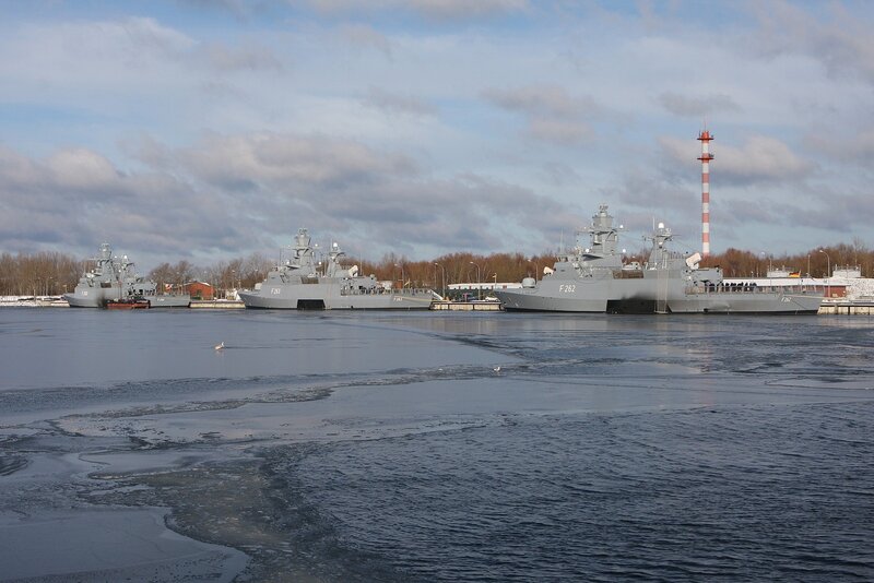 Naval ships in a frozen harbor