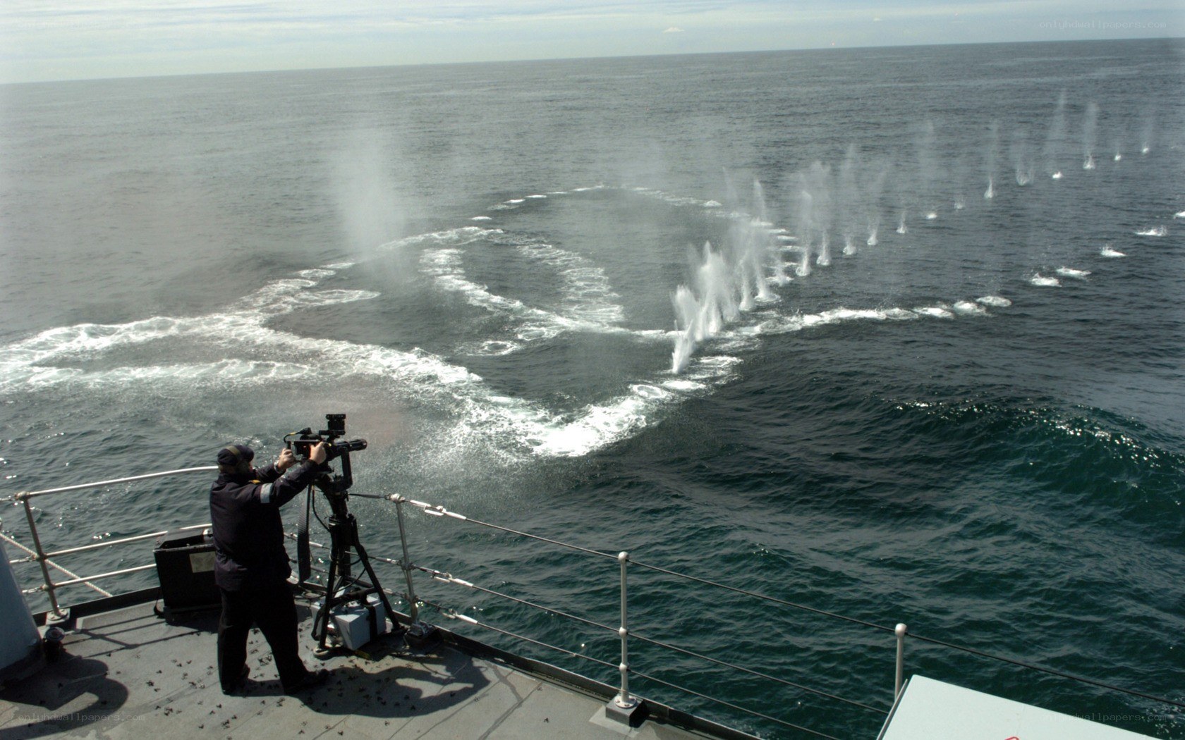 Naval vessel firing water cannons