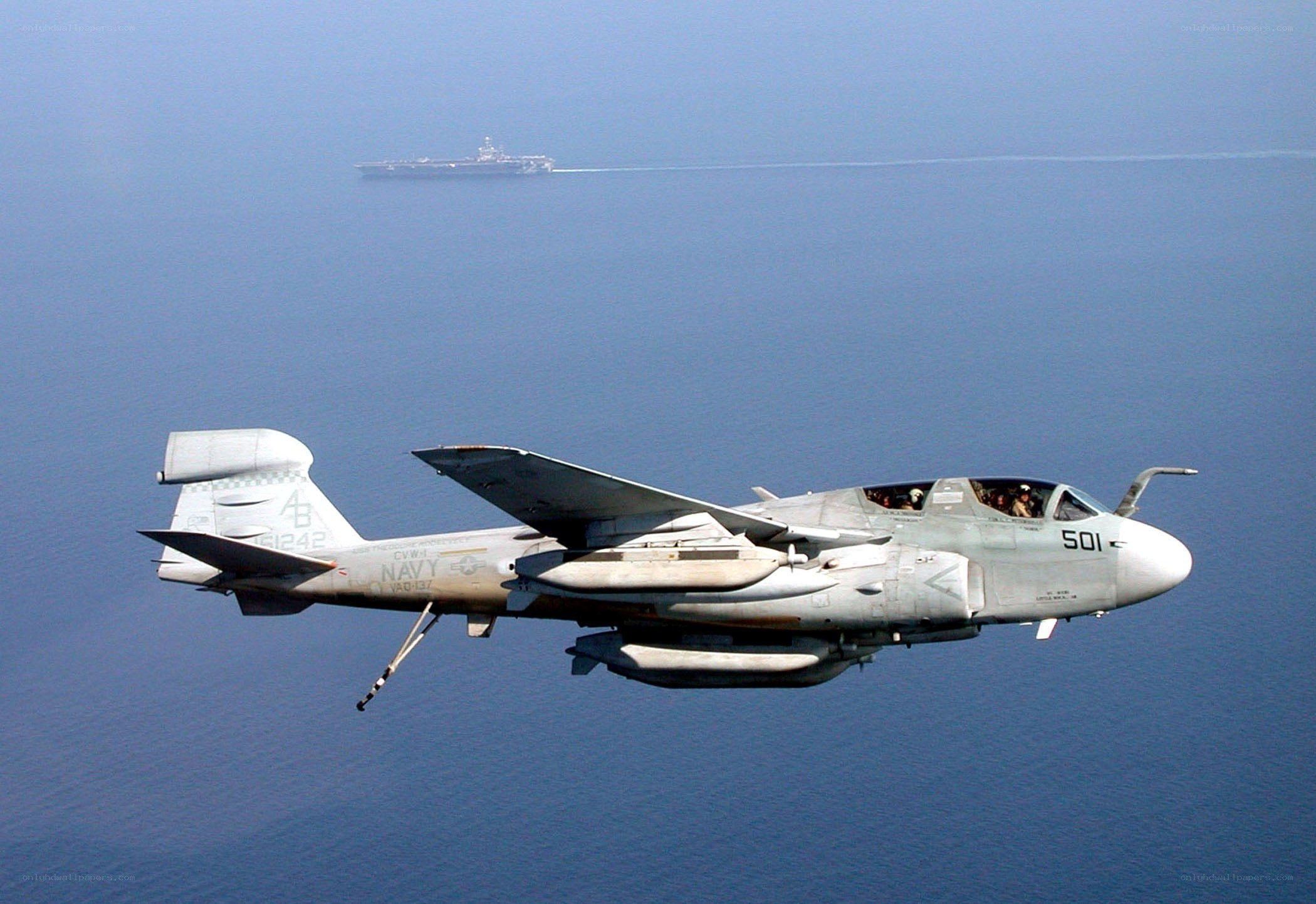 Navy aircraft flying over ocean