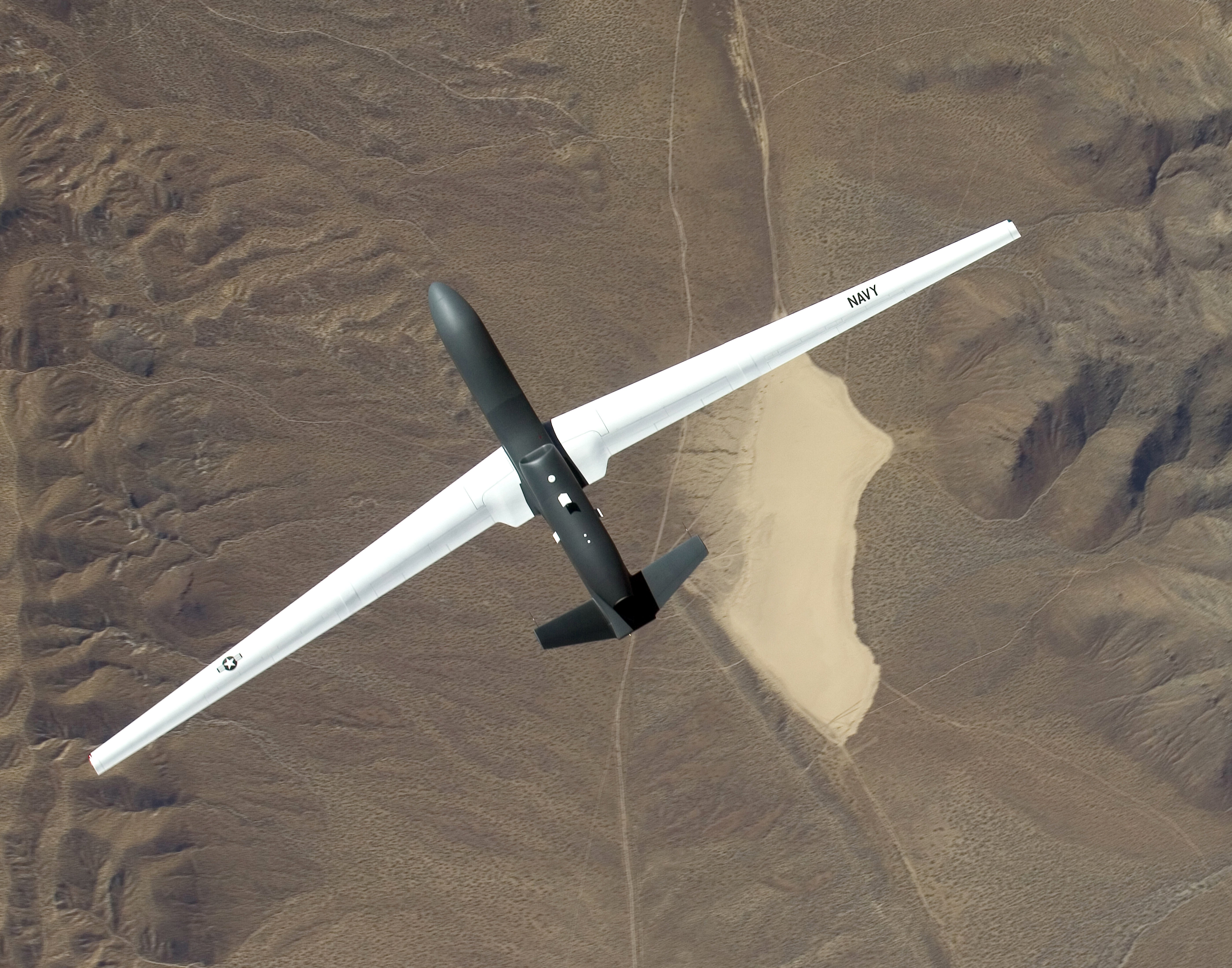 Navy drone flying over desert
