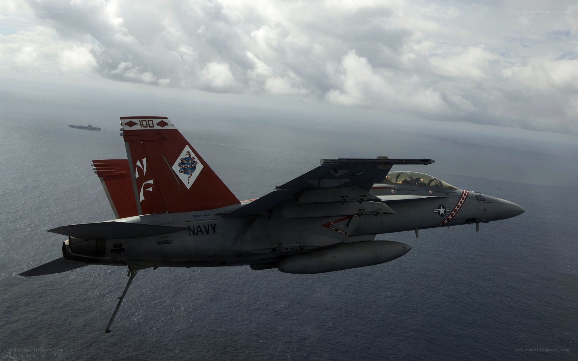 Navy fighter jet over ocean
