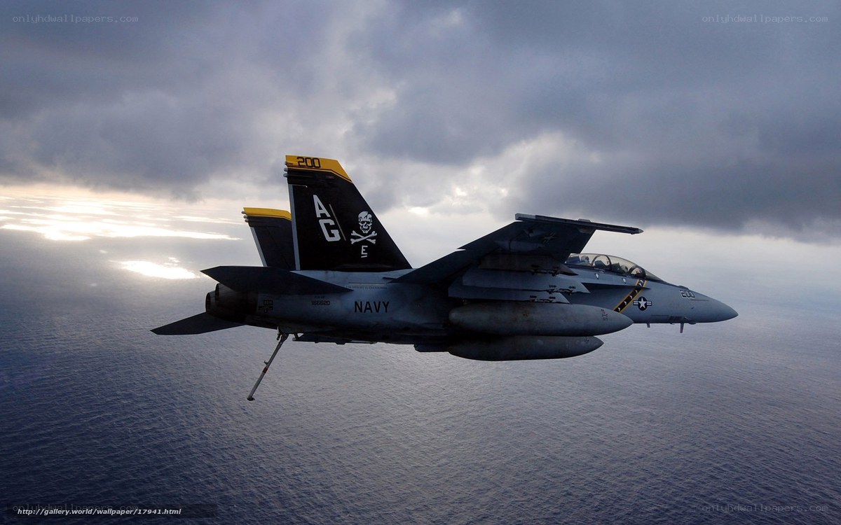 Navy fighter jet over ocean