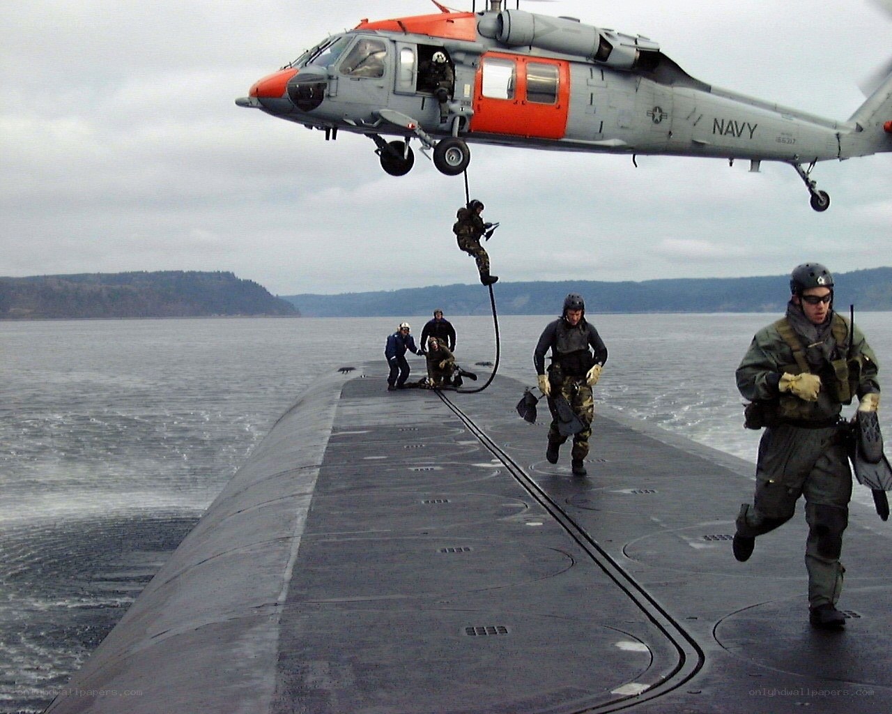 Navy helicopter boarding submarine
