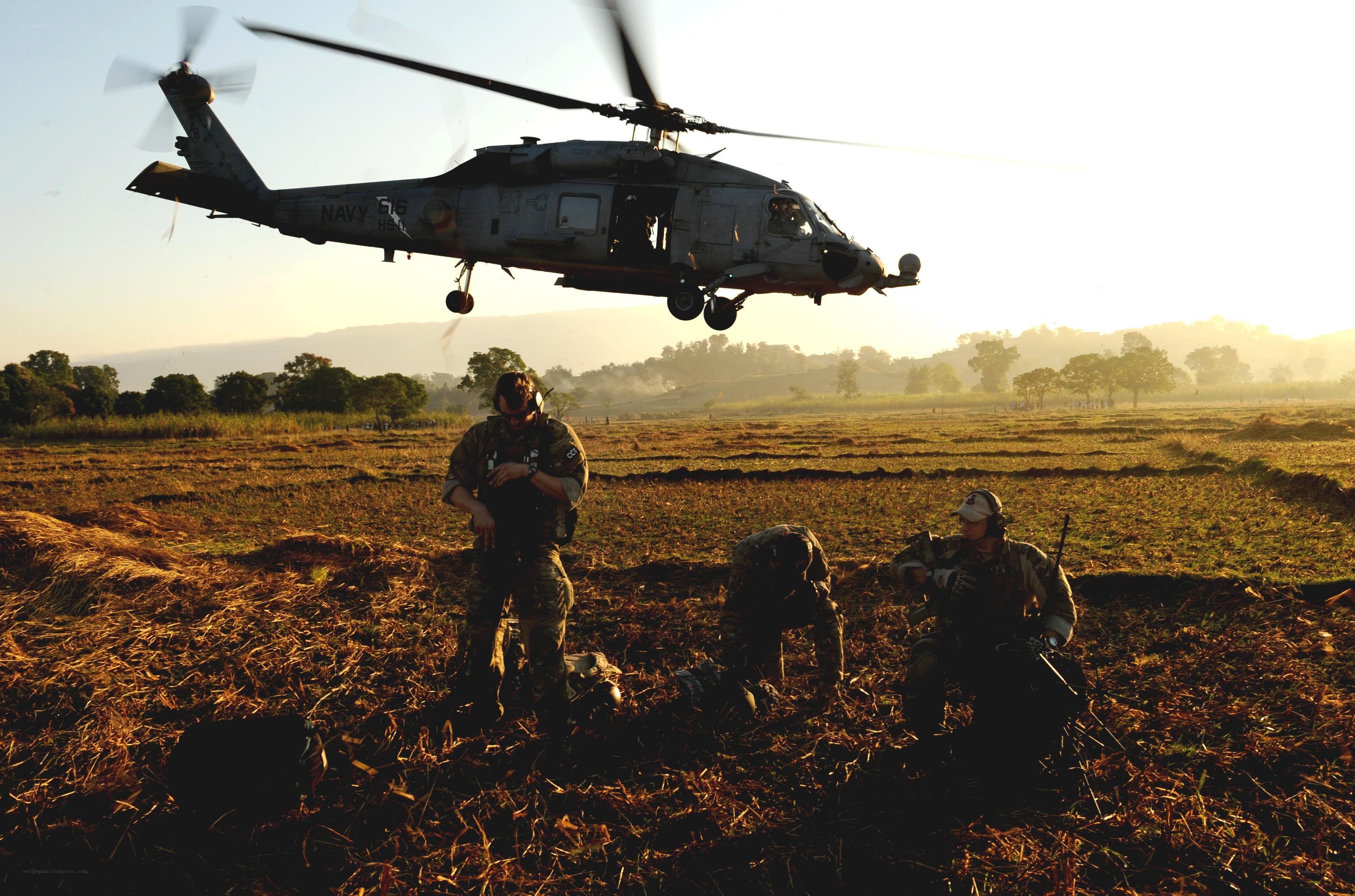 Navy helicopter landing in field
