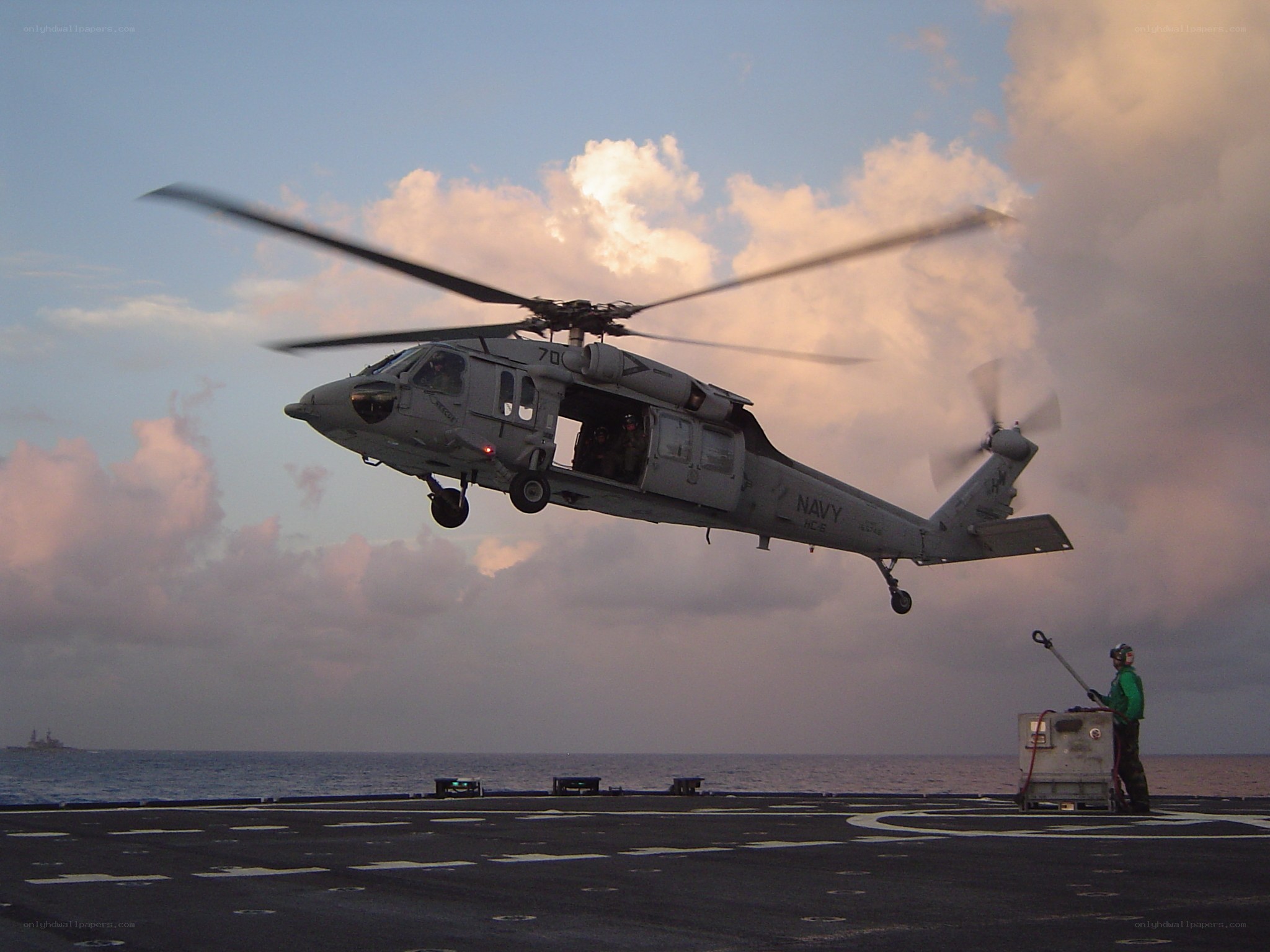 Navy helicopter landing on ship