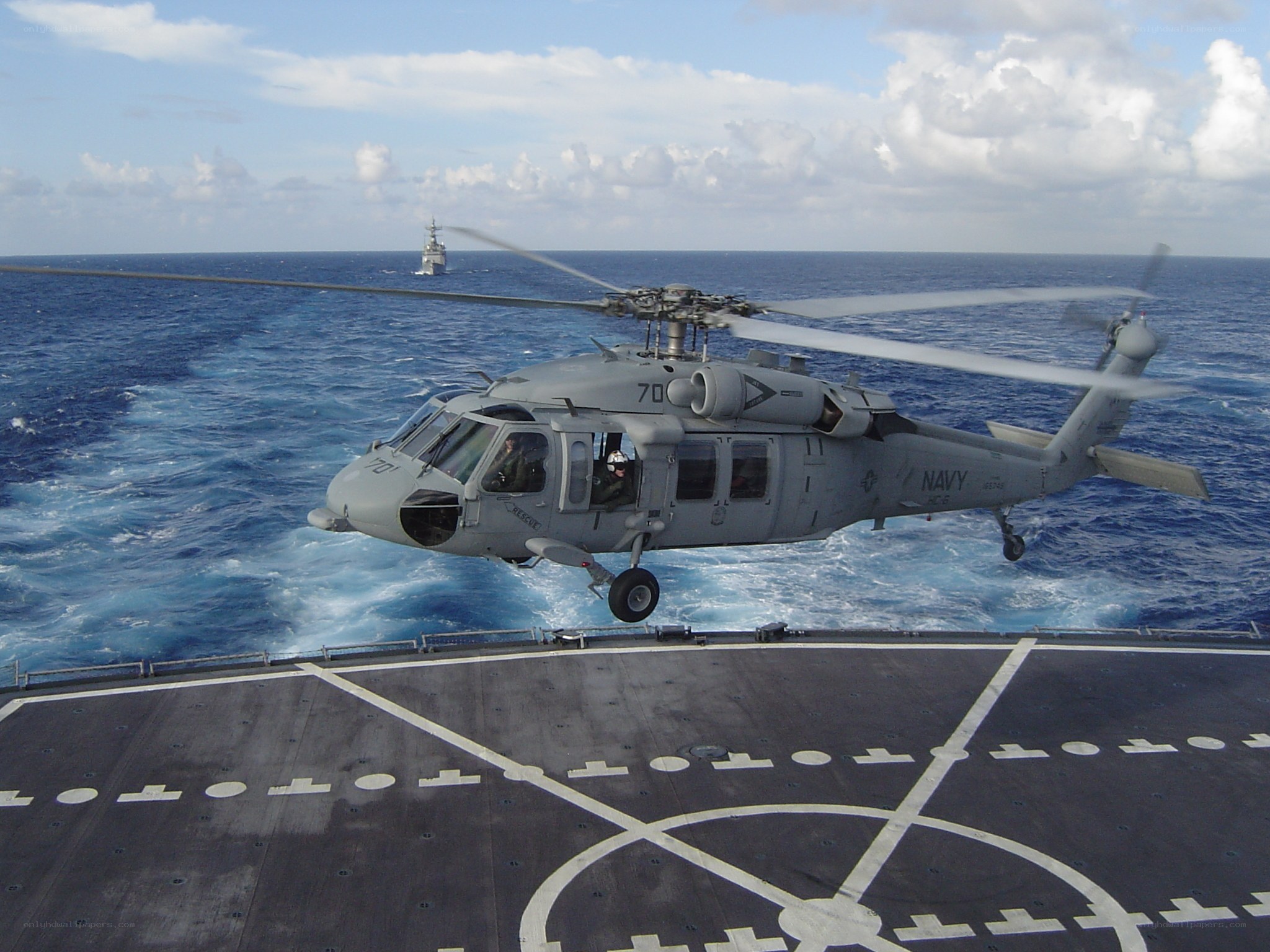 Navy helicopter landing on ship