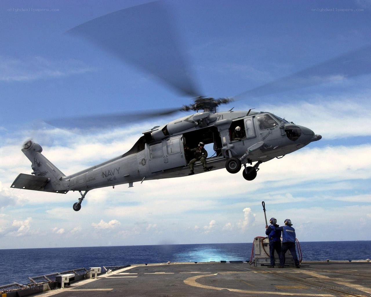 Navy helicopter landing on ship