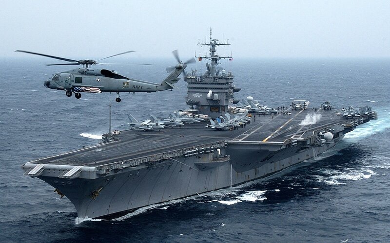 Navy helicopter near aircraft carrier