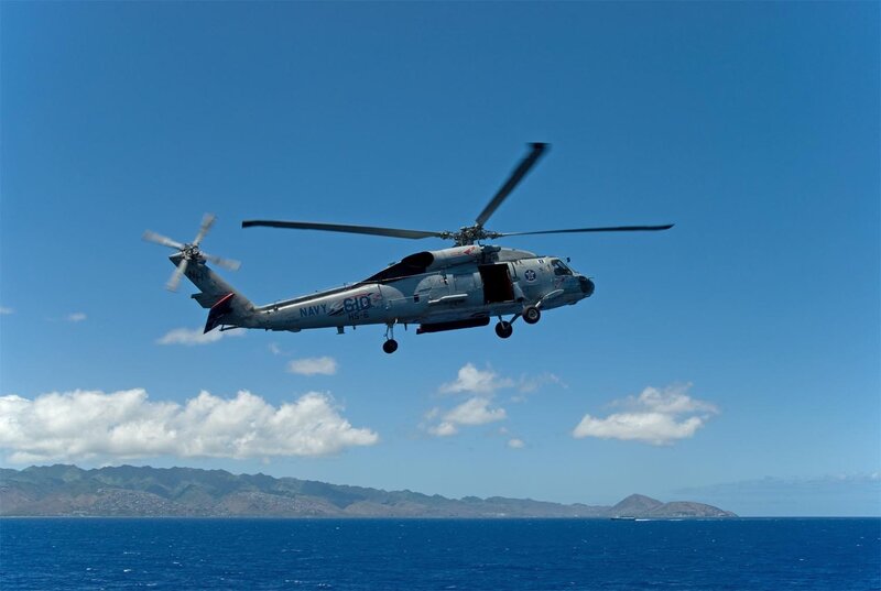 Navy helicopter over ocean