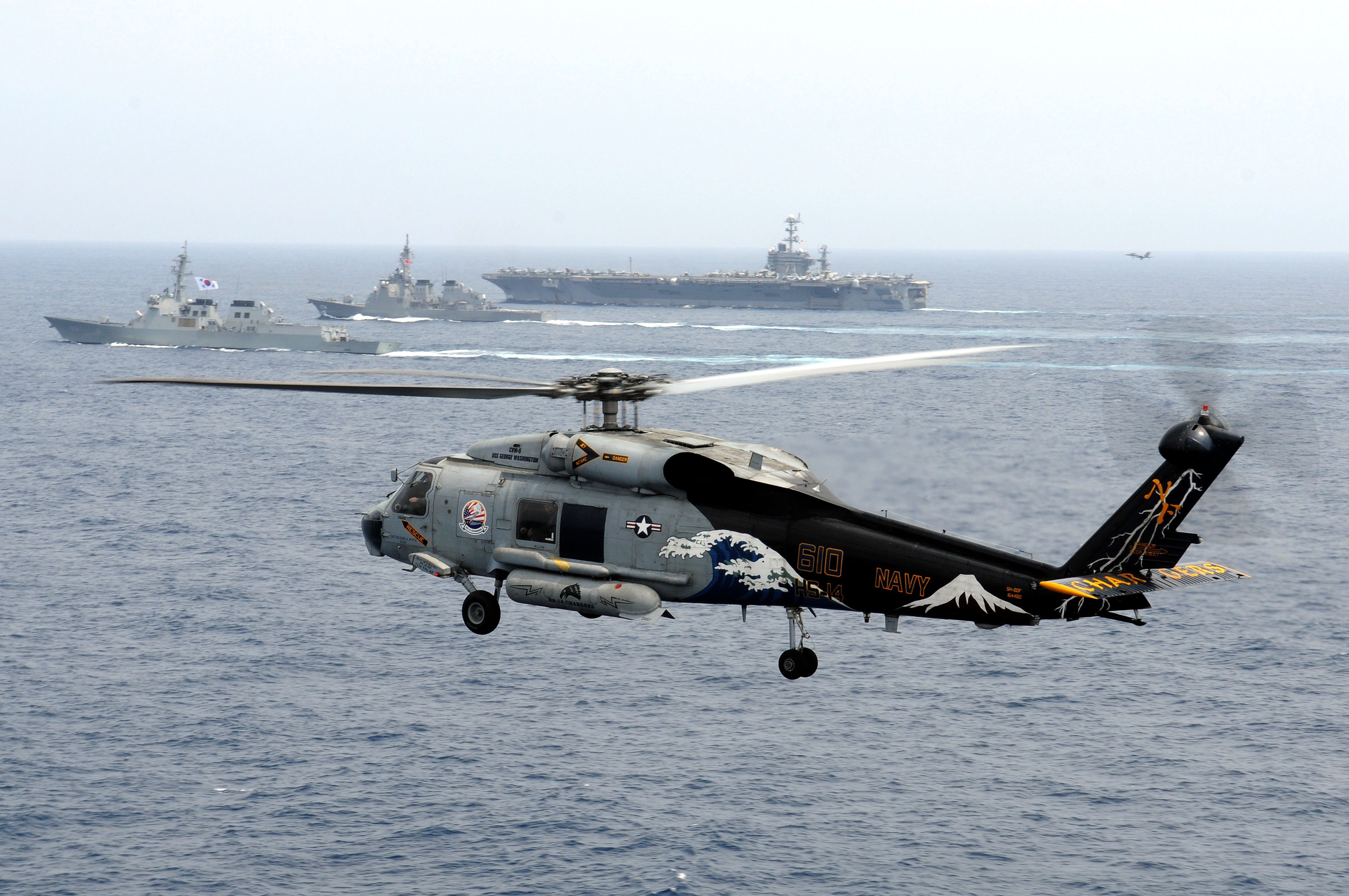 Navy helicopter over ocean