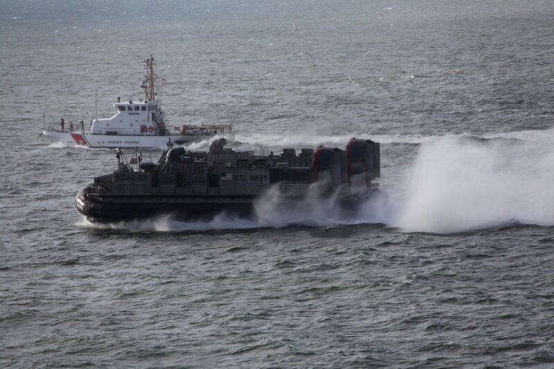 Navy hovercraft with Coast Guard vessel