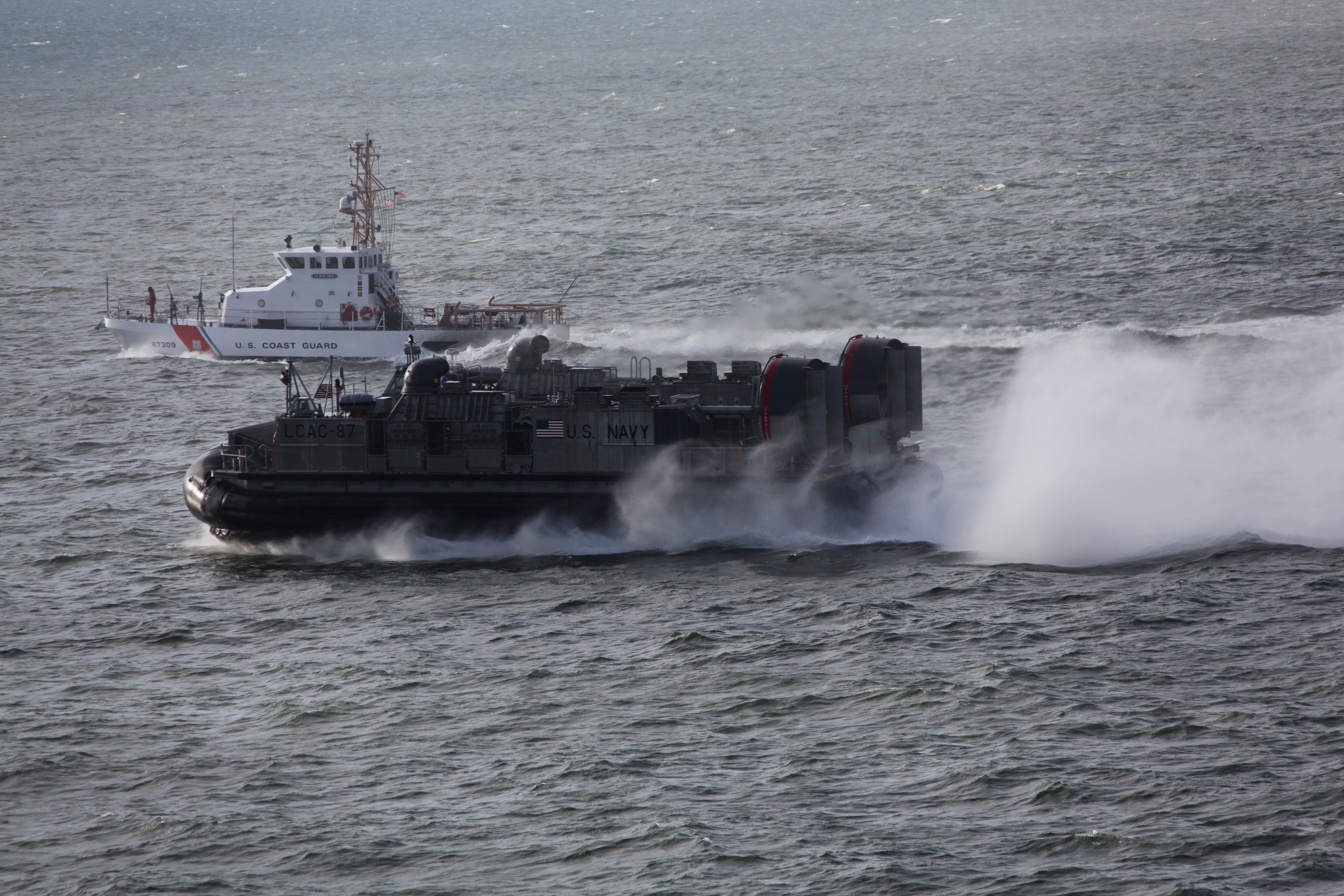 Navy hovercraft with Coast Guard vessel