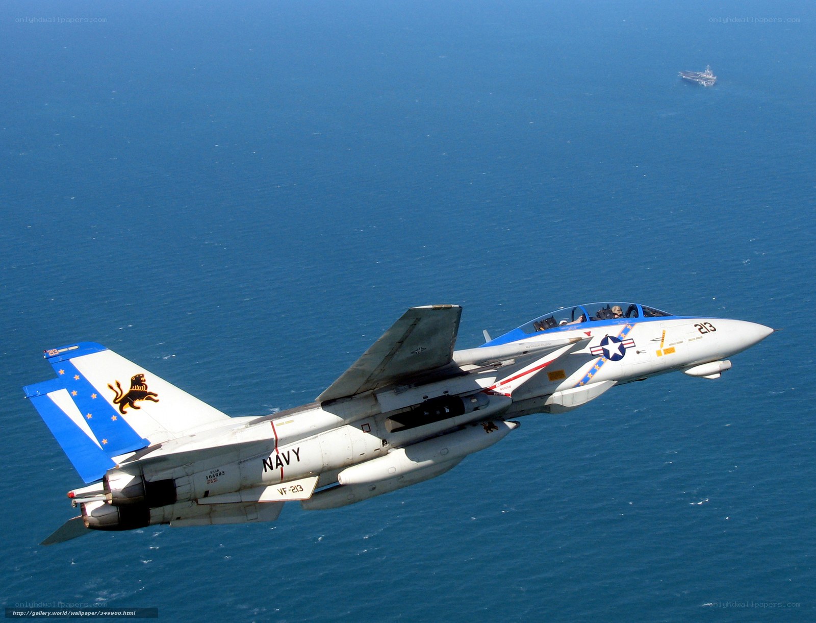 Navy jet flying over ocean