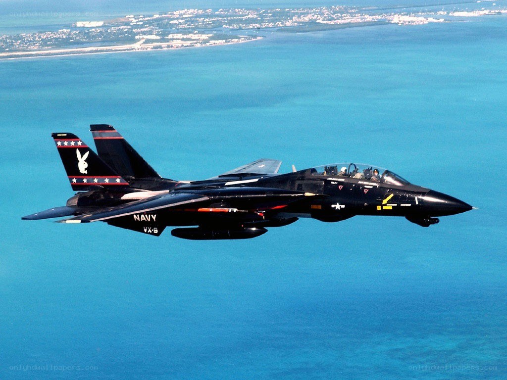 Navy jet flying over ocean