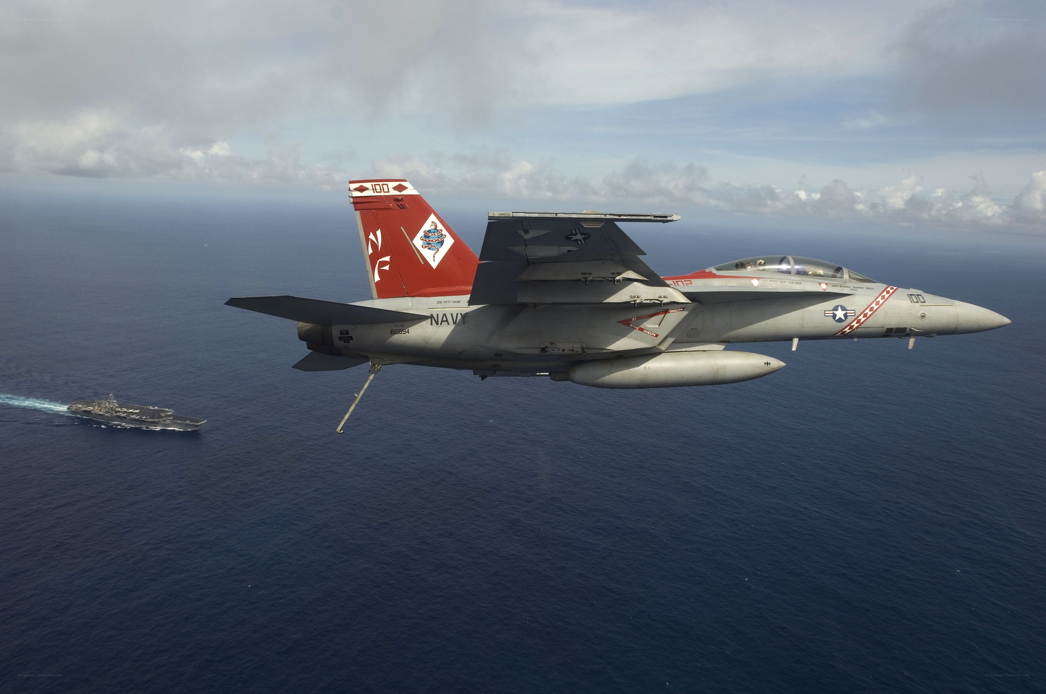 Navy jet flying over ocean