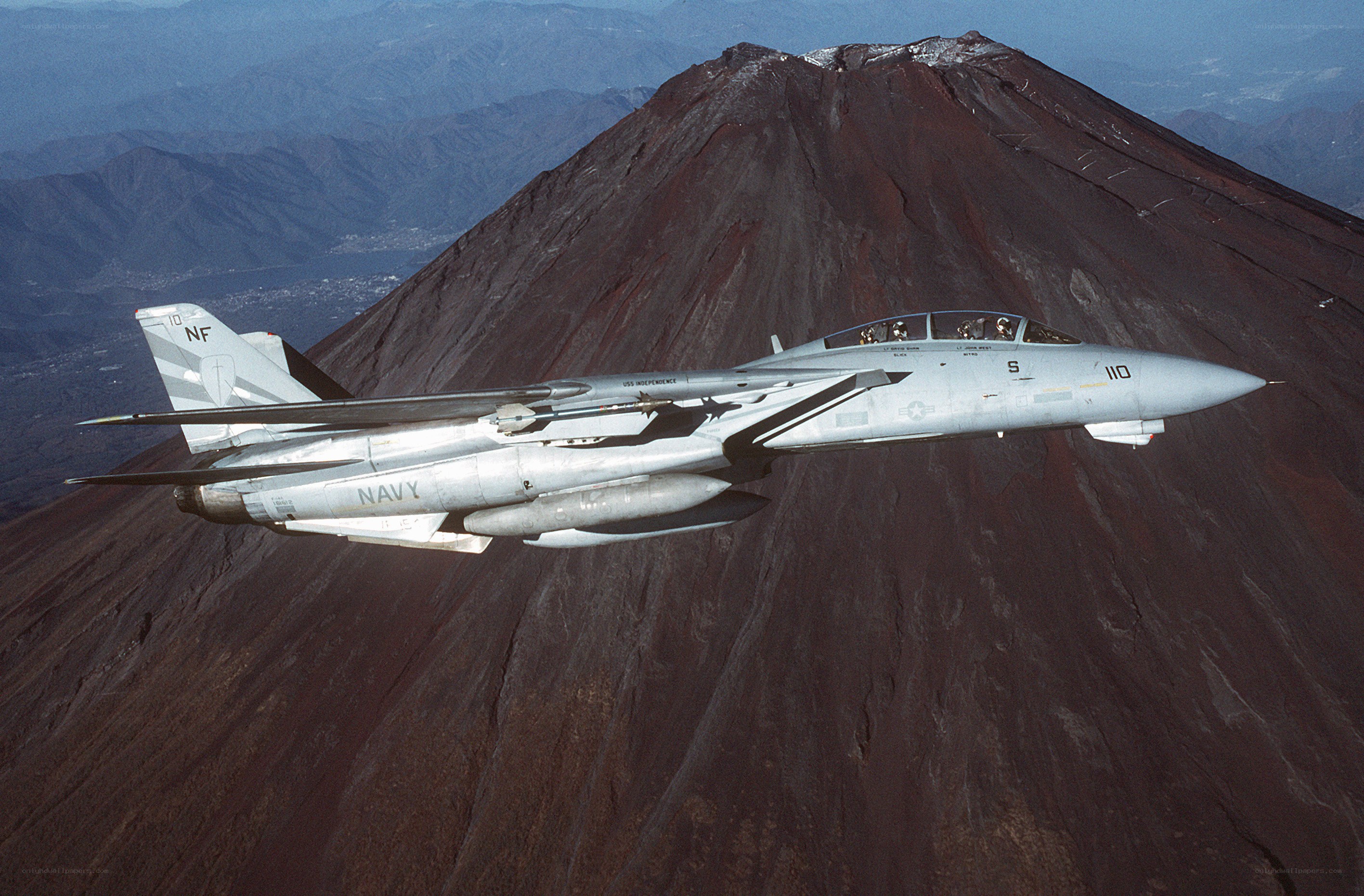 Navy jet flying over volcano