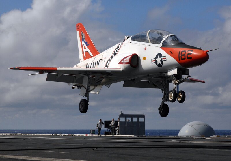 Navy jet landing on aircraft carrier