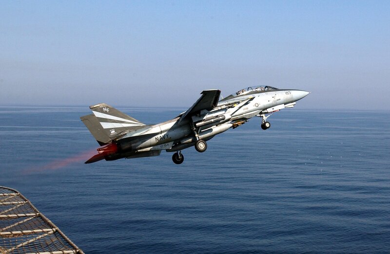 Navy jet taking off from aircraft carrier