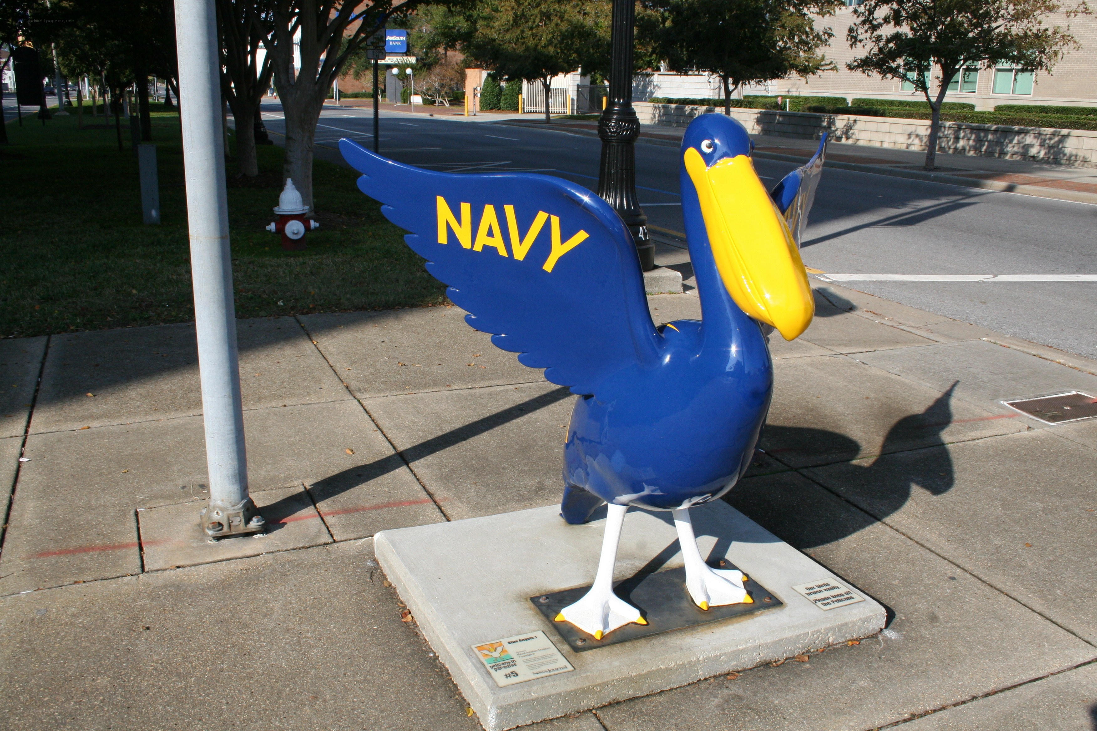 Navy pelican statue on sidewalk
