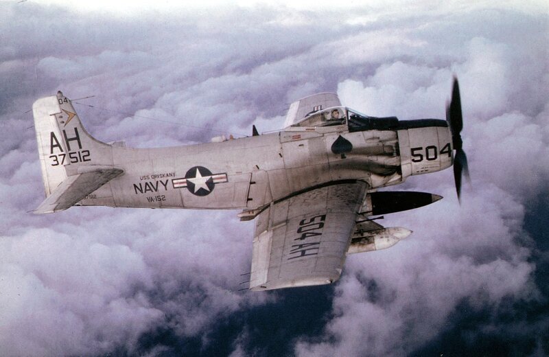 Navy propeller plane in clouds
