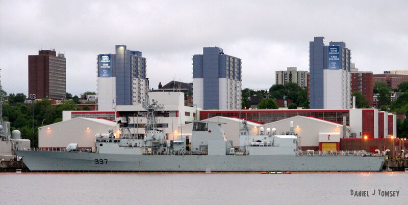 navy ship in city harbor