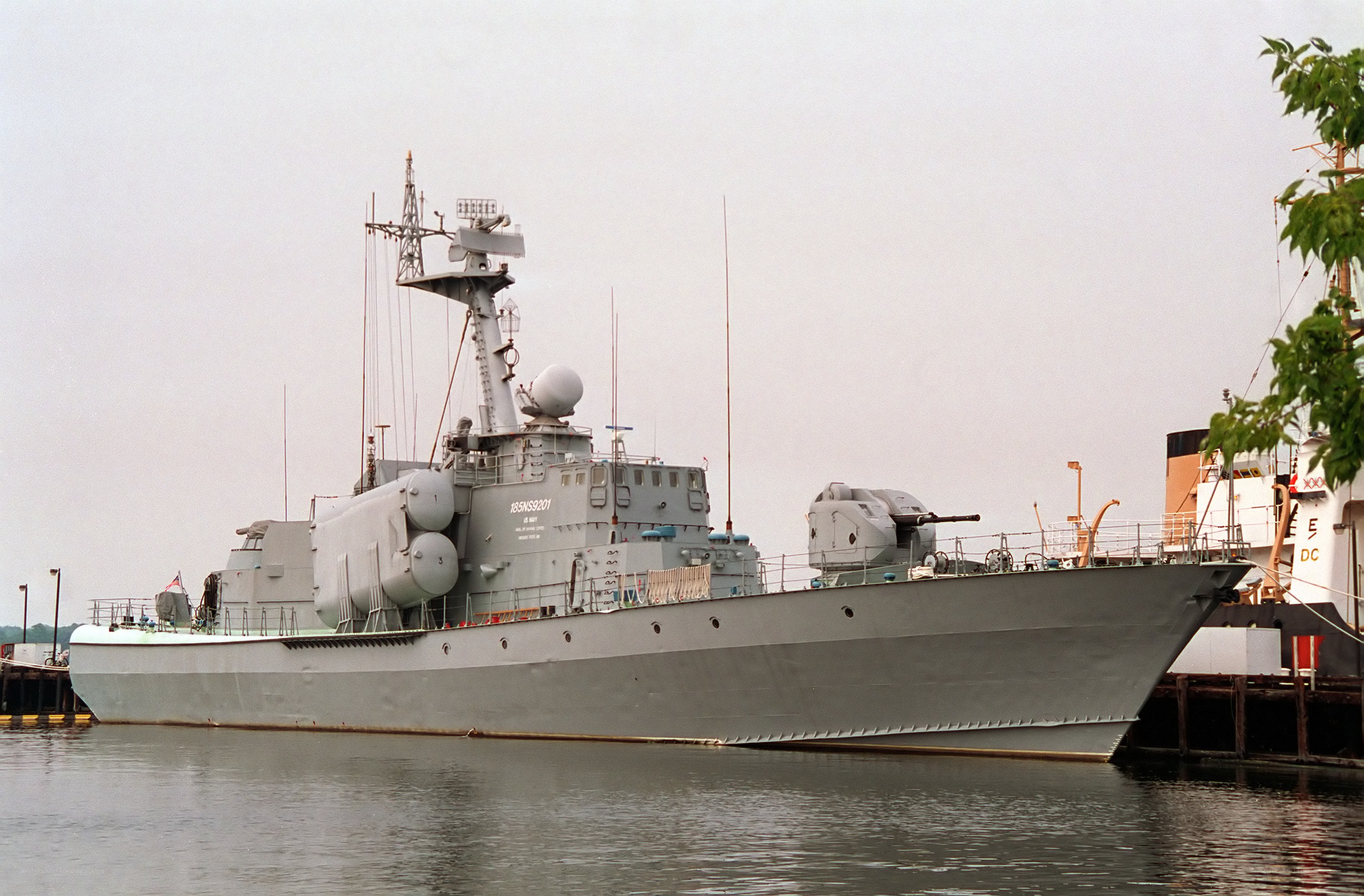 navy warship docked at port