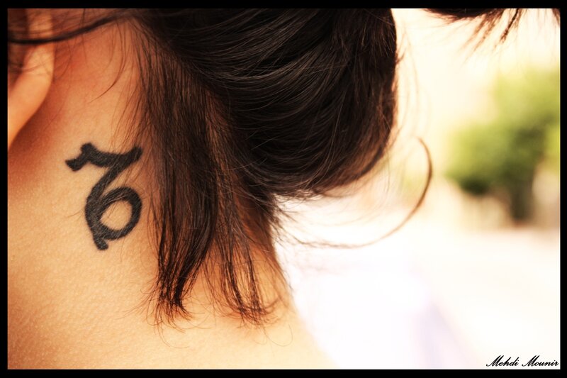 neck tattoo of zodiac symbol