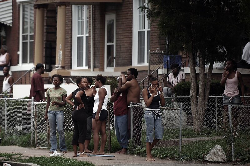 Neighbors gather on a city sidewalk
