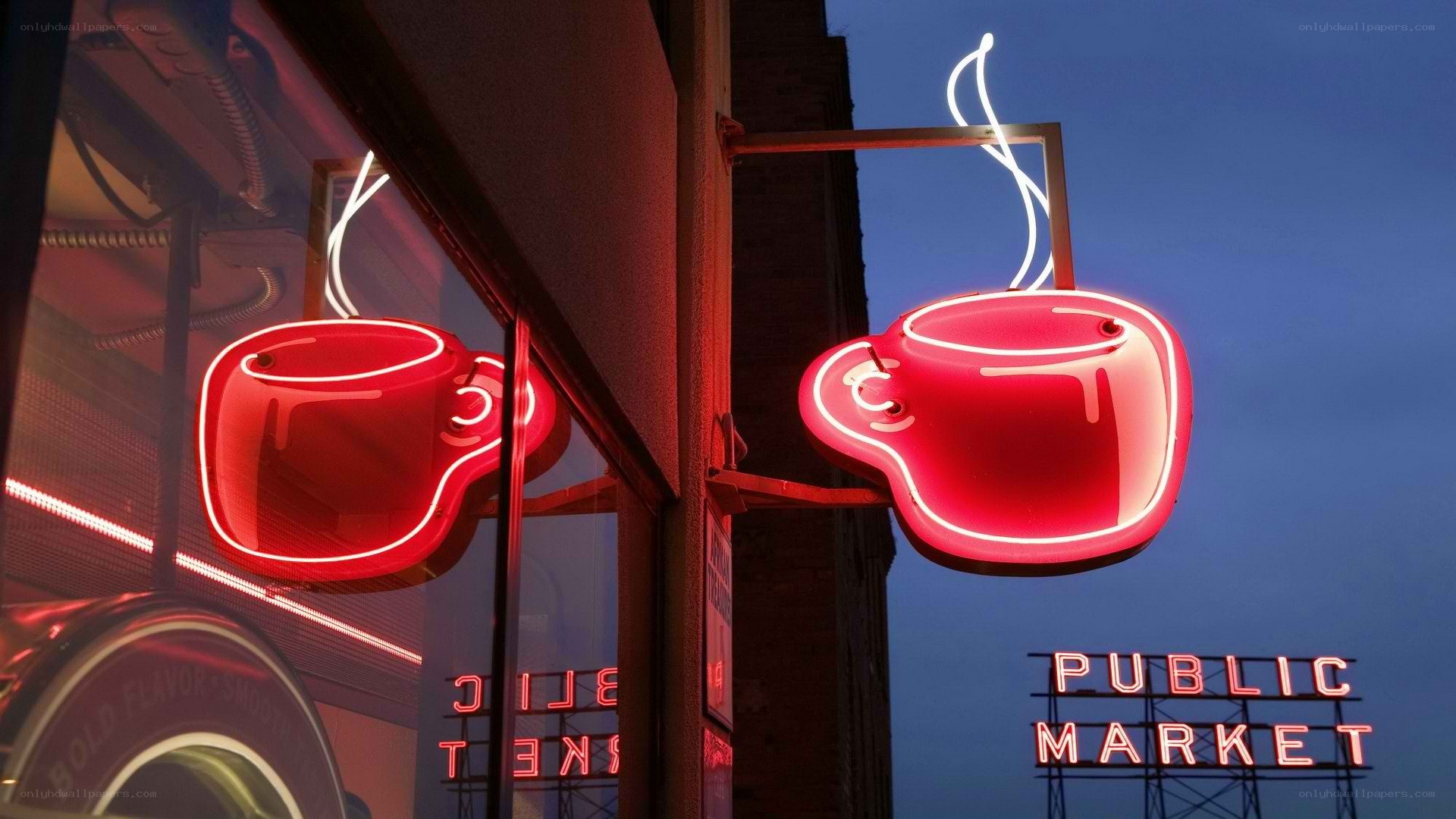 Neon coffee cup sign at dusk